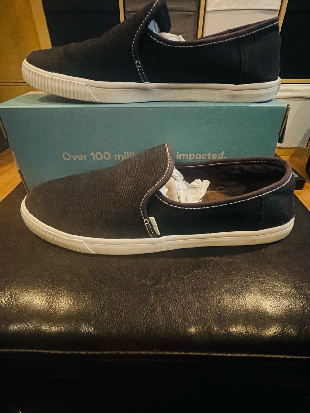 Toms Black Canvas Slip-On Sneakers with White Soles and Contrast Stitching